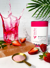 An image of a sugar free delicious pink collagen drink that has been fortified with biotin, vitamin c, pre & probiotics and hyaluronic acid on a marble counter